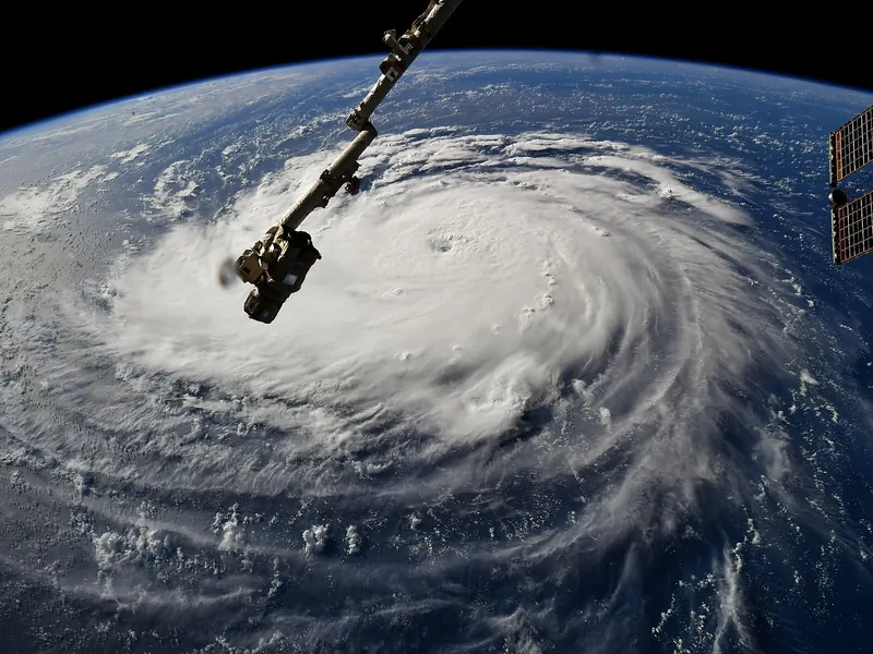 A giant swirl of cloud over a deep blue ocean, seen from orbit