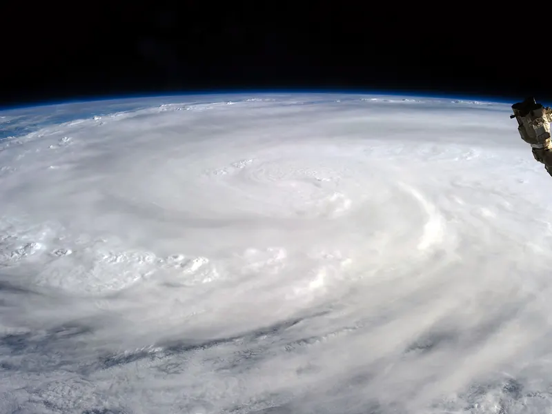 A huge typhoon with a small, sharp eye, seen from orbit above the Pacific