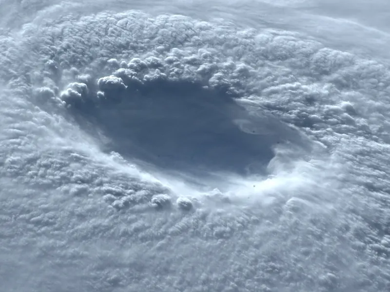 Looking down into the eye of a typhoon from space, with cloud spiralling around it