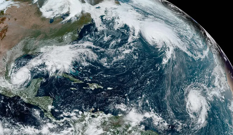 A satellite view of the Atlantic with three separate hurricanes spinning at the same time